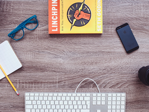 Keyboard, Notebook, Lens, Phone, Book and Glasses on Desk